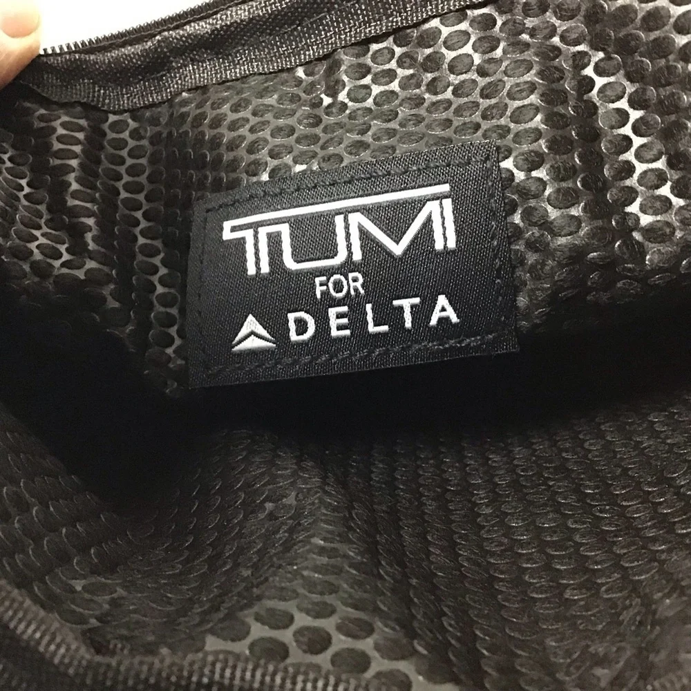 Almost complete Tumi amenities bag.
